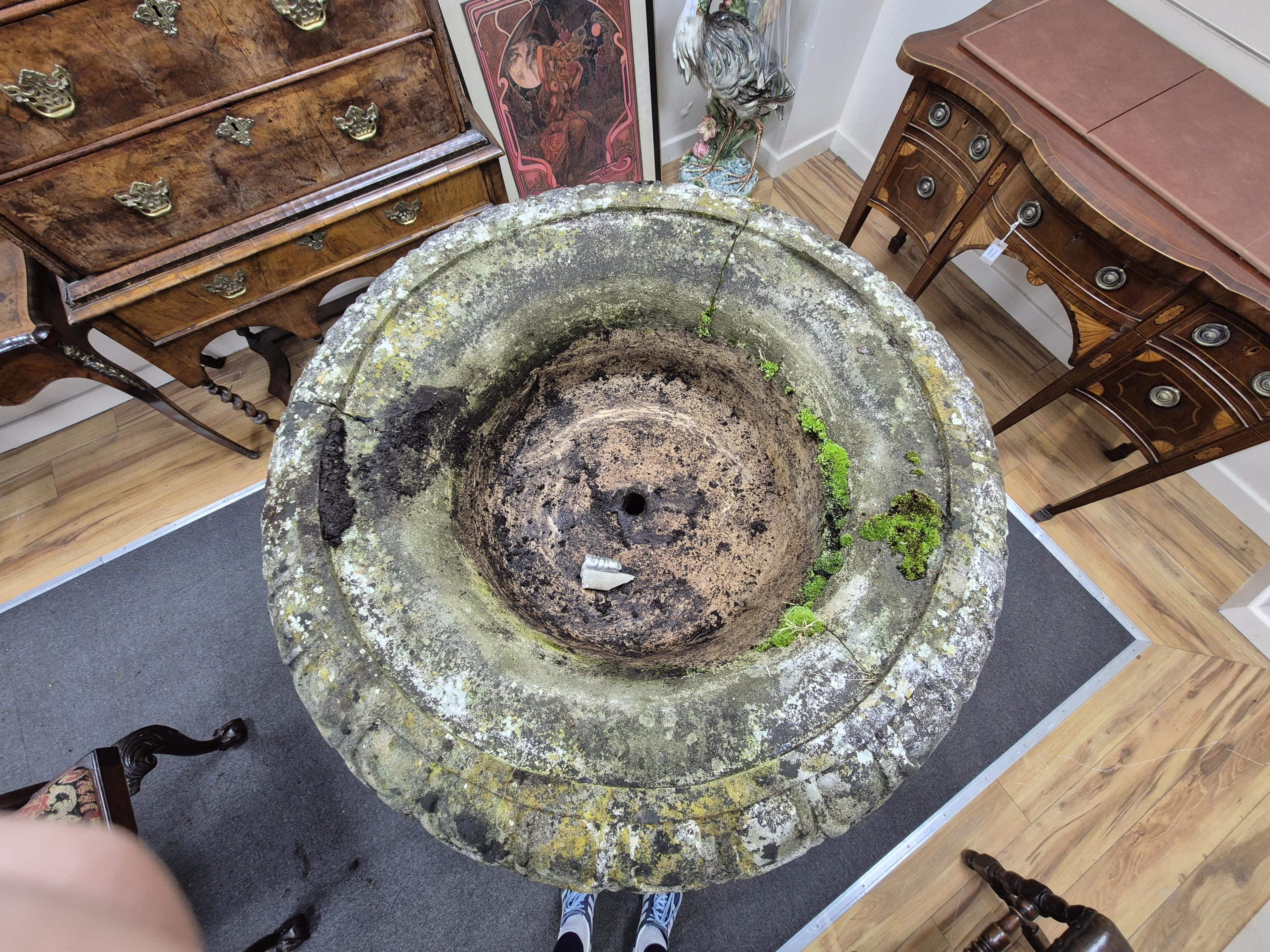 A reconstituted stone bird bath